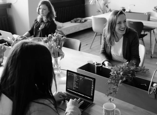 3 women happily working at computers